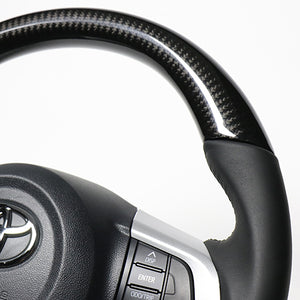 REAL ORIGINAL SERIES SOFT D SHAPE BLACK CARBON BLACK STITCH STEERING WHEEL FOR TOYOTA PIXIS MEGA LA700A:LATE LA710A:LATE  M90-BKC-BK