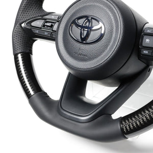 REAL ORIGINAL SERIES D SHAPE BLACK CARBON BLACK STITCH STEERING WHEEL FOR TOYOTA YARIS CROSS MXPJ10 MXPB10 TYJ-BKC